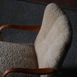 Pair of Mid Century Modern Swedish lounge chairs in birch and lamb's wool, 1960s.