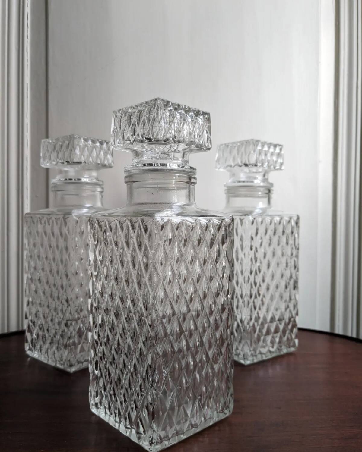 3 diamond-patterned chiseled glass carafes