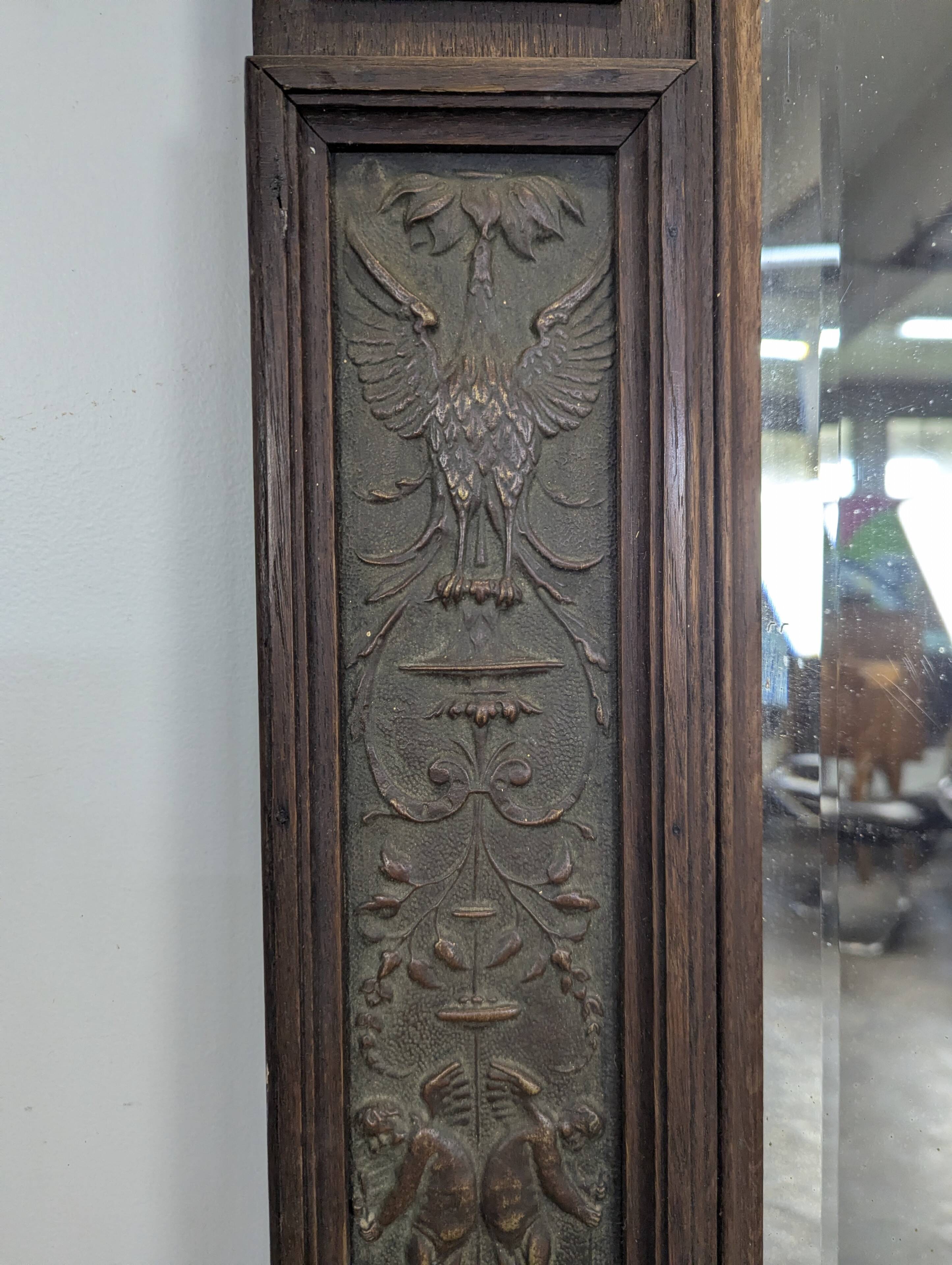 Renaissance-style mirror in wood and copper with a craftsmanship theme.