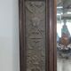 Renaissance-style mirror in wood and copper with a craftsmanship theme.