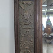 Renaissance-style mirror in wood and copper with a craftsmanship theme.