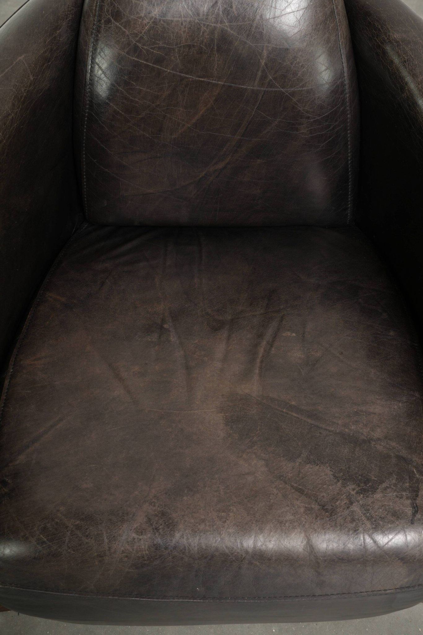 Cow leather Aviator design armchair in a dark colour scheme