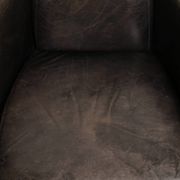 Cow leather Aviator design armchair in a dark colour scheme