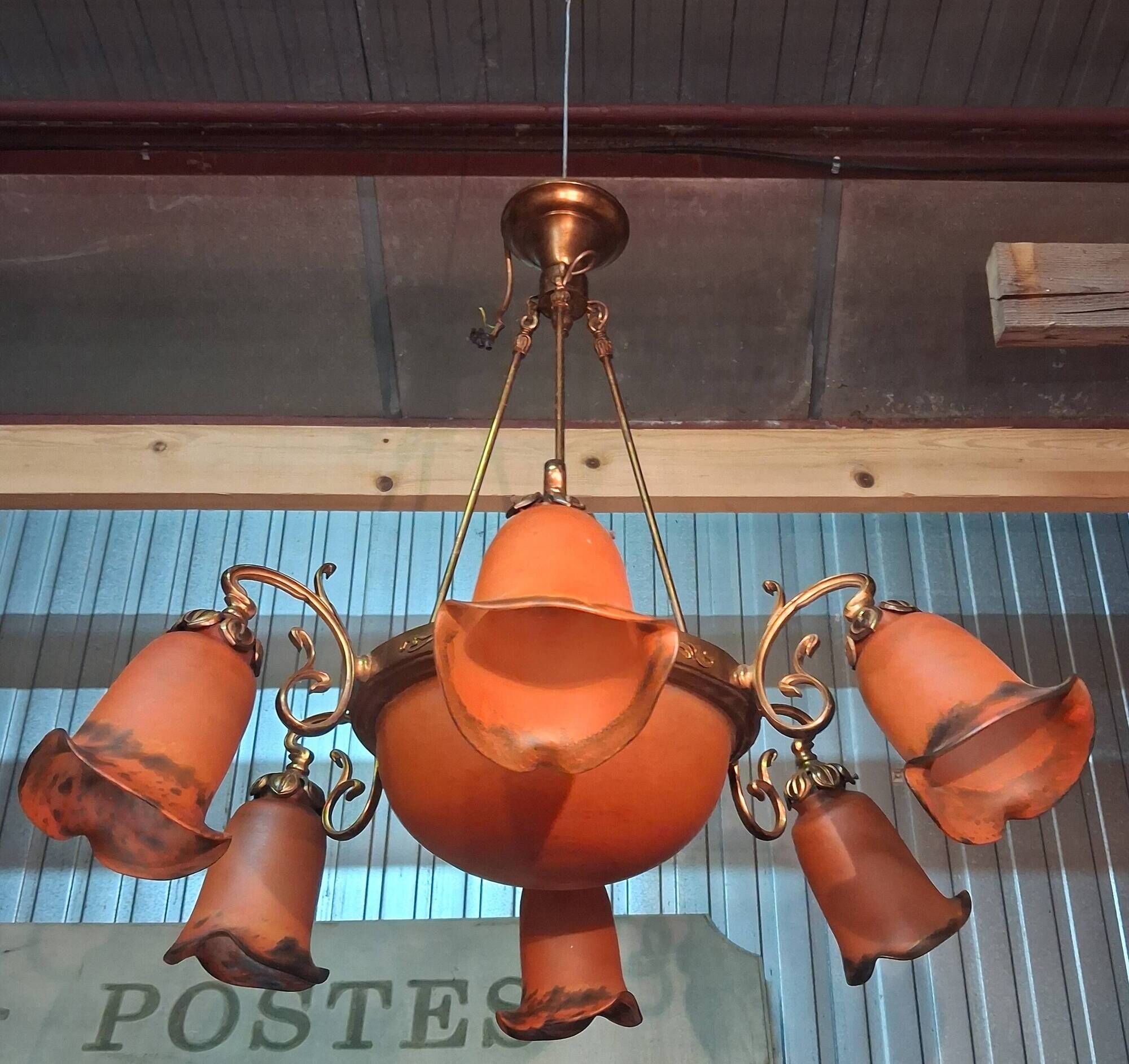 Pair of Art Nouveau style chandeliers in bronze and orange glass paste.