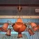 Pair of Art Nouveau style chandeliers in bronze and orange glass paste.