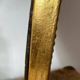 Oval-shaped wooden mirror in gold color