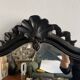 Miroir Napoléon III en bois noir à fronton