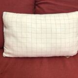 Beige linen cushion with checkered pattern and shiny dark gray piping