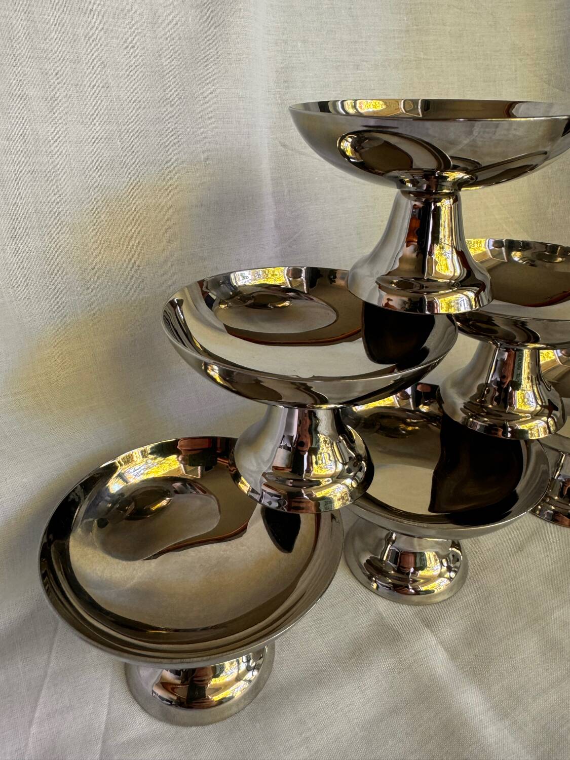 Set of 6 stainless steel ice cream bowls by Guy Degrenne with matching spoons.
