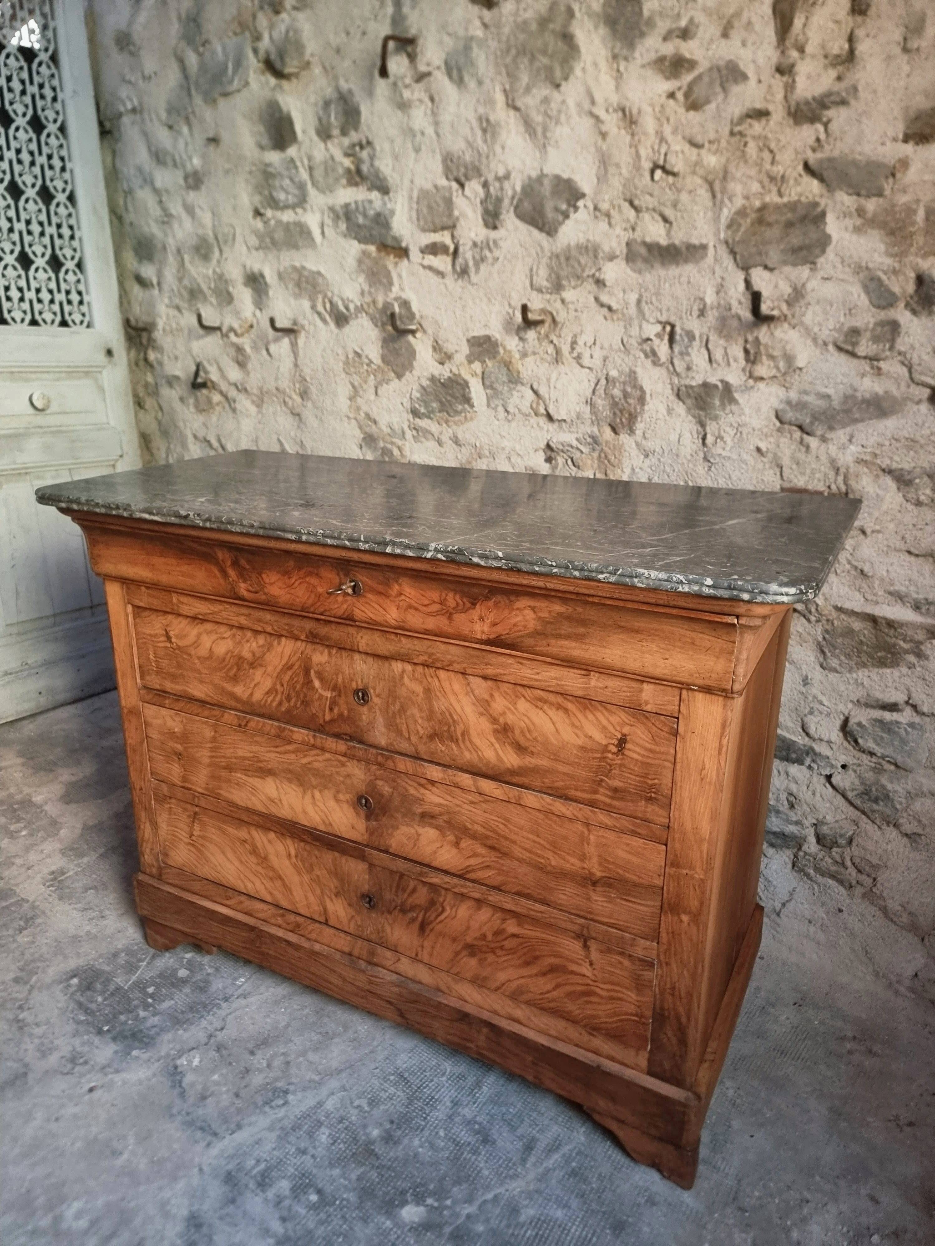 French antique walnut commode with a dark grey marble top, circa 1830–1860.