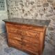 French antique walnut commode with a dark grey marble top, circa 1830–1860.