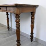 Antique writing table in the Napoleon III style with turned wooden legs.