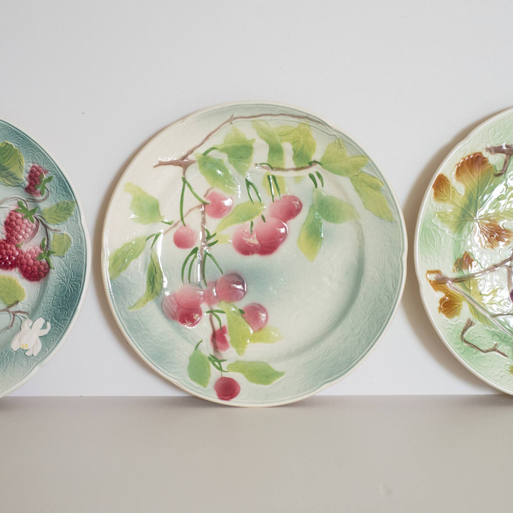 3 antique dessert plates decorated with fruit in slurry of Saint Clement
