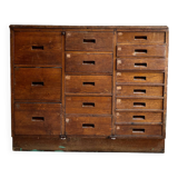 Craftsman's cabinet with 16 drawers in dark wood.