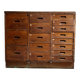 Craftsman's cabinet with 16 drawers in dark wood.
