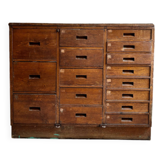 Craftsman's cabinet with 16 drawers in dark wood.