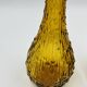 Set of two vintage textured amber glass Empoli bottles.