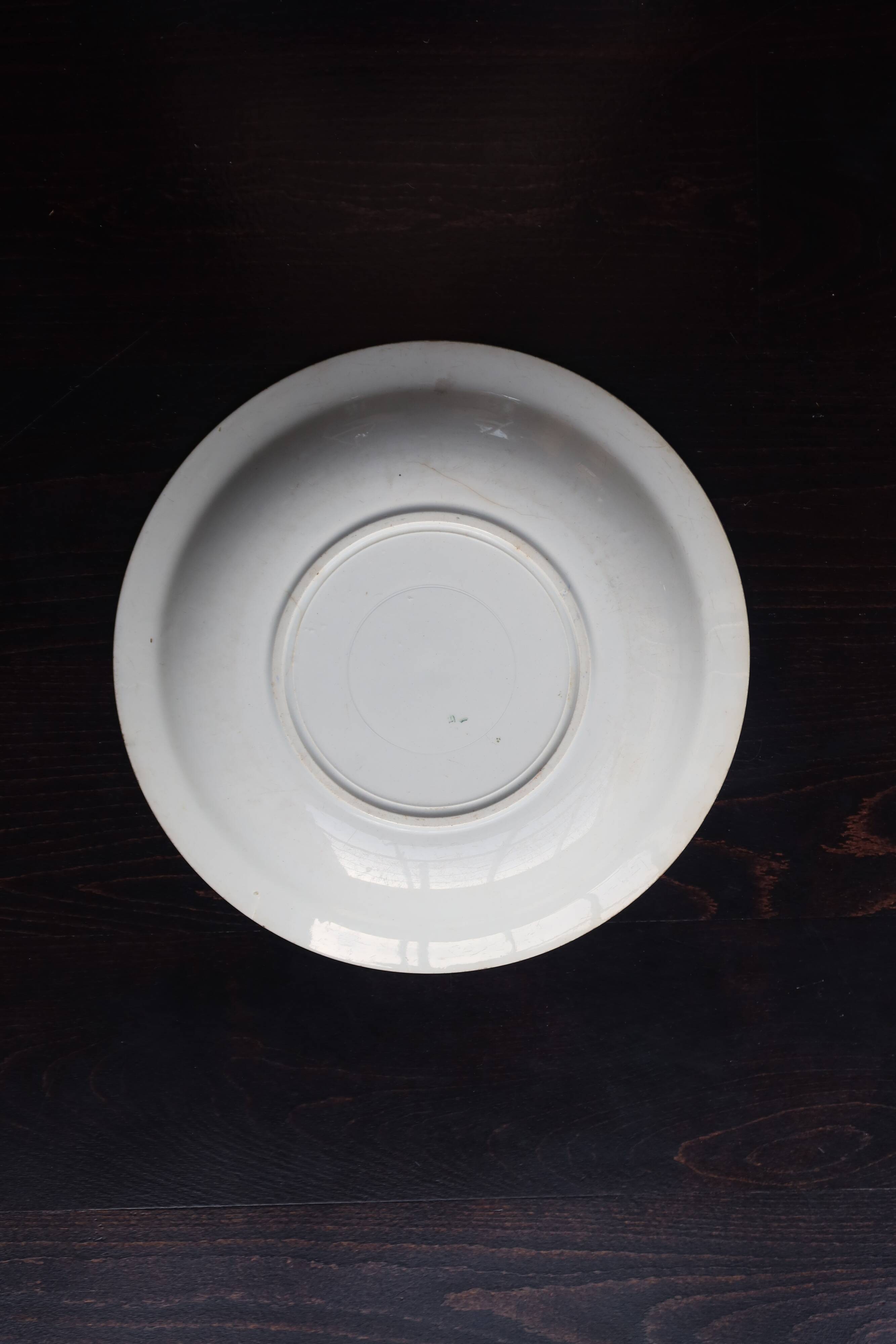 Antique shallow dish from Badonviller with blue flower decoration.