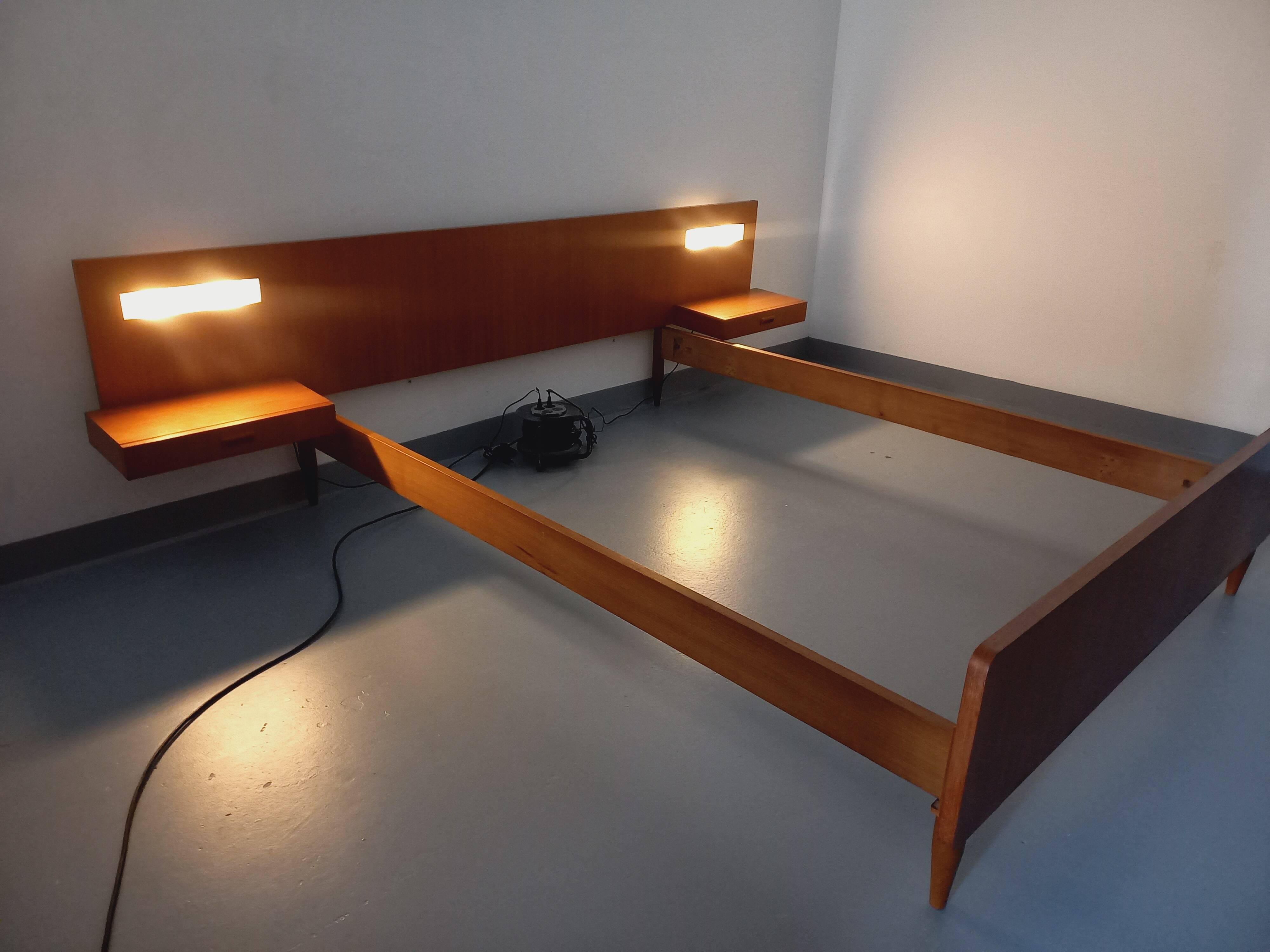 Double bed in vintage Scandinavian style from the 1960s with bedside tables.