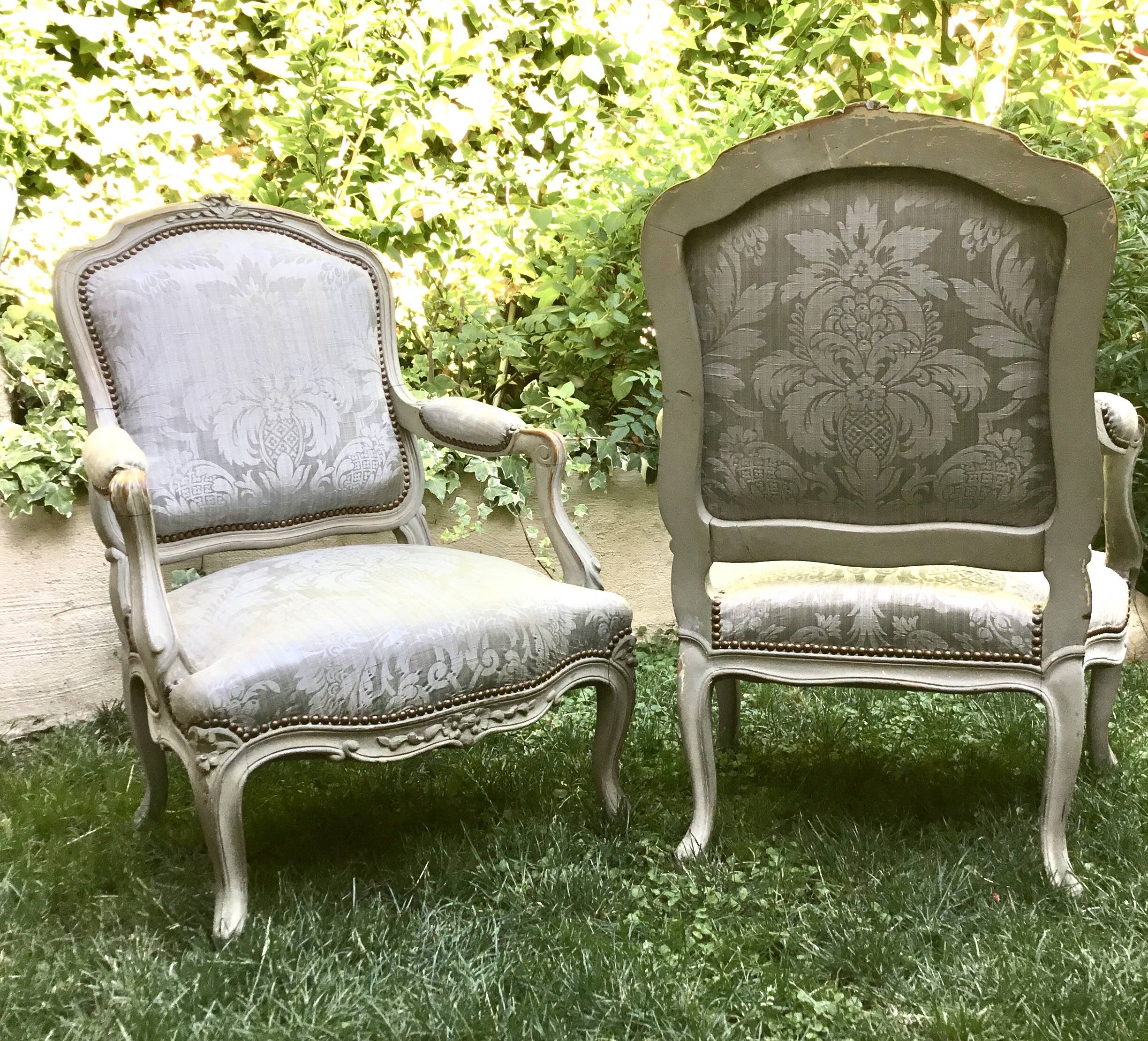 Pair of Louis XV style armchairs in grey lacquered wood.
