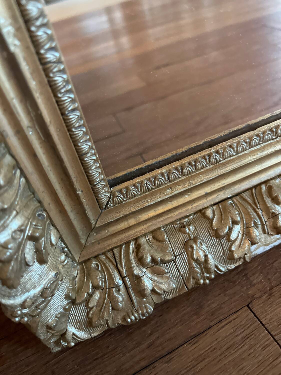Antique mirror with a wooden and gilded stucco frame.