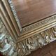 Antique mirror with a wooden and gilded stucco frame.