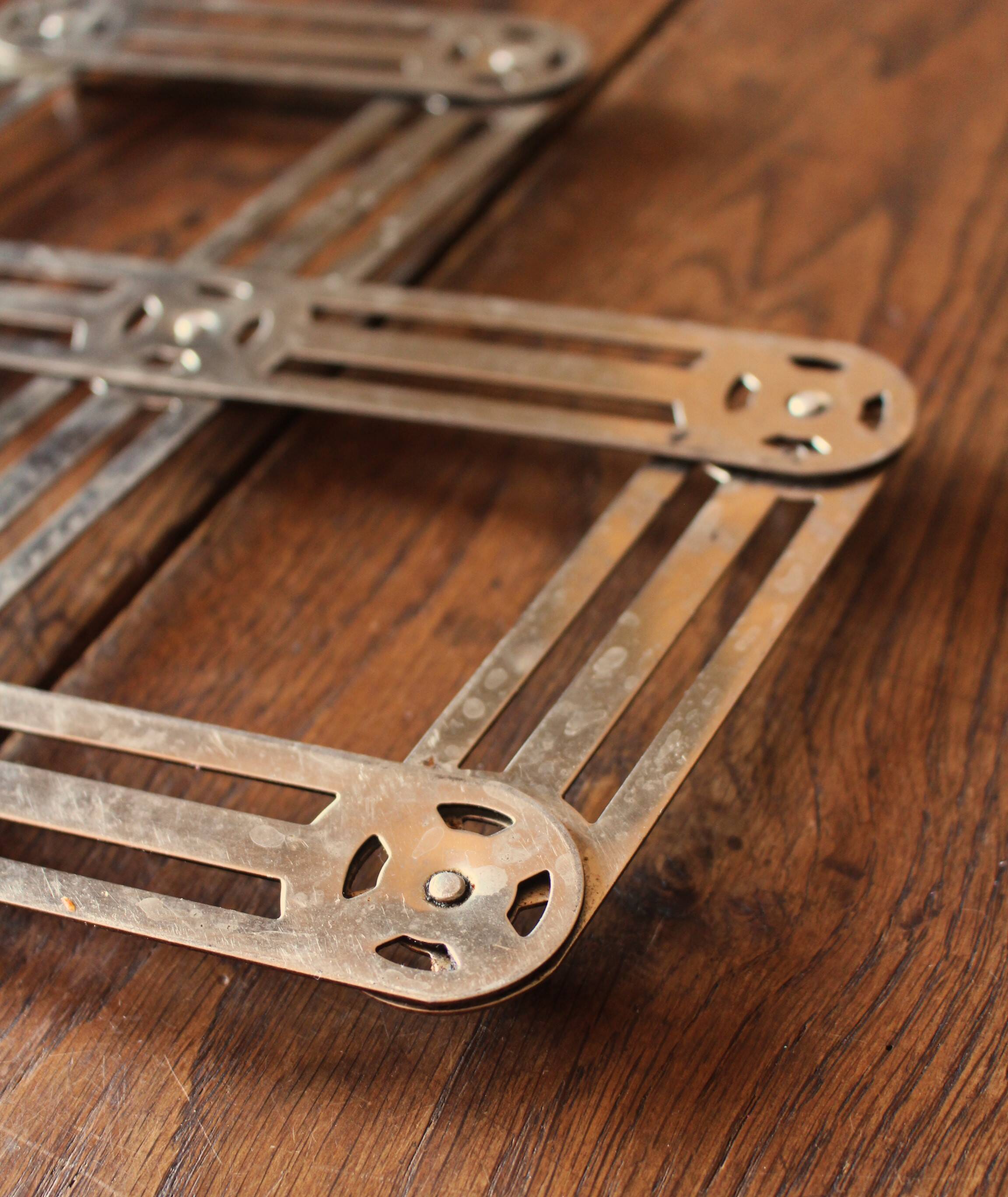 Vintage accordion folding metal trivet
