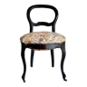 Black curved wooden chair with floral seat