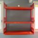 Modular red metal wall shelf in Congresso Lips Vago style.