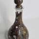 Carafe artisanale en verre soufflé et cuivre patiné décor brutaliste 90 cm