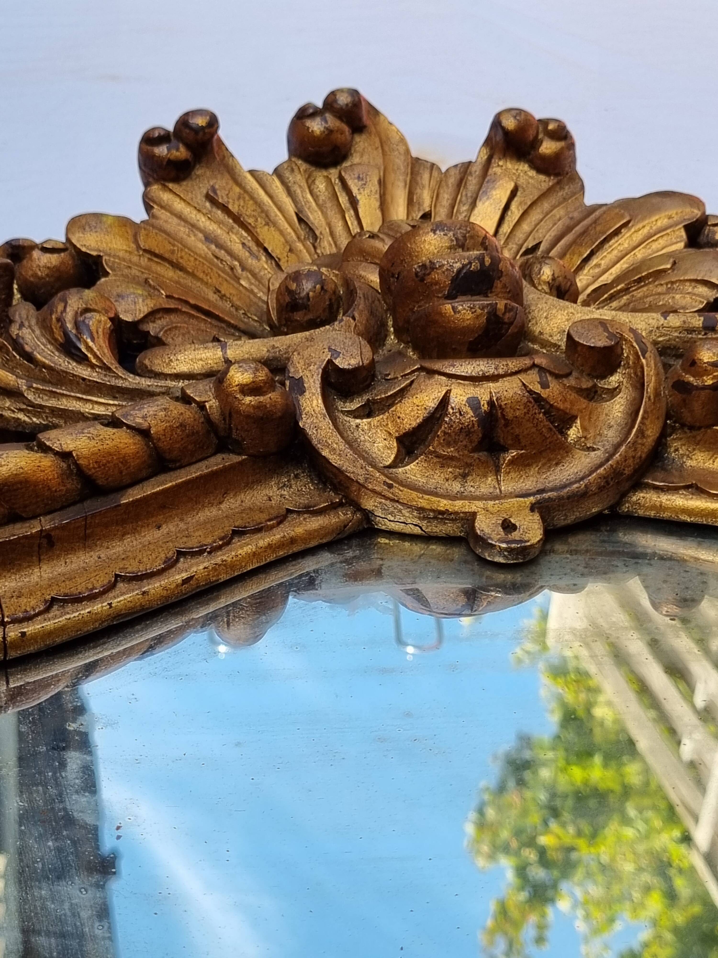 Antique wall mirror in carved gilded wood, Louis XV style, 19th century, 98 x 57 cm.