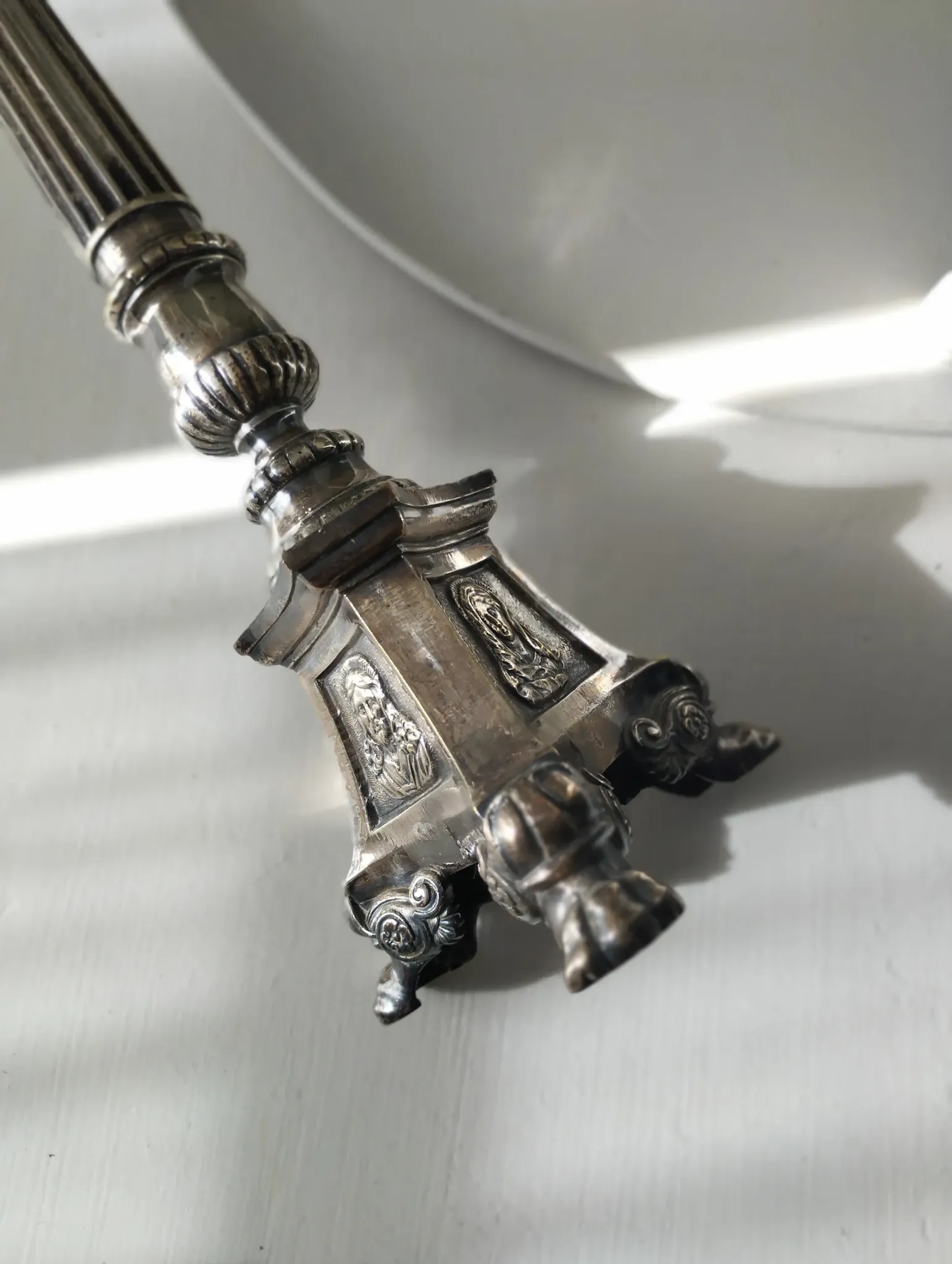 Old church candlestick in silver-plated metal