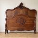 Antique carved bed in Louis XV style made of wood.