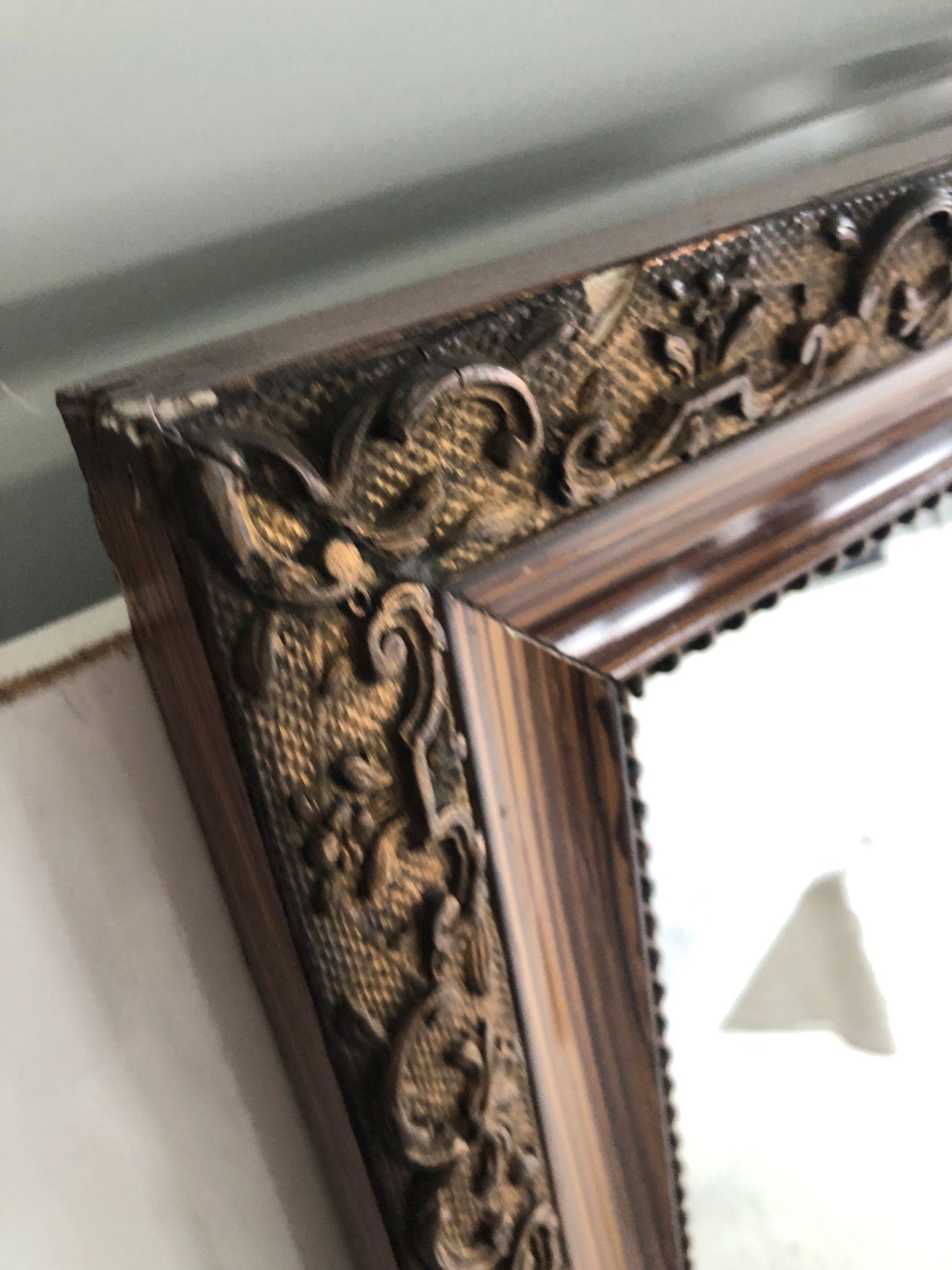 Old mirror with wooden frame and plaster moldings