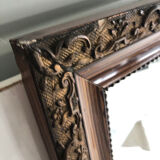 Old mirror with wooden frame and plaster moldings