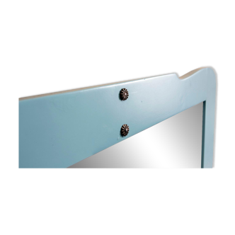 Large antique mirror with a solid wood frame painted turquoise and with red accents, mirror effect glass.