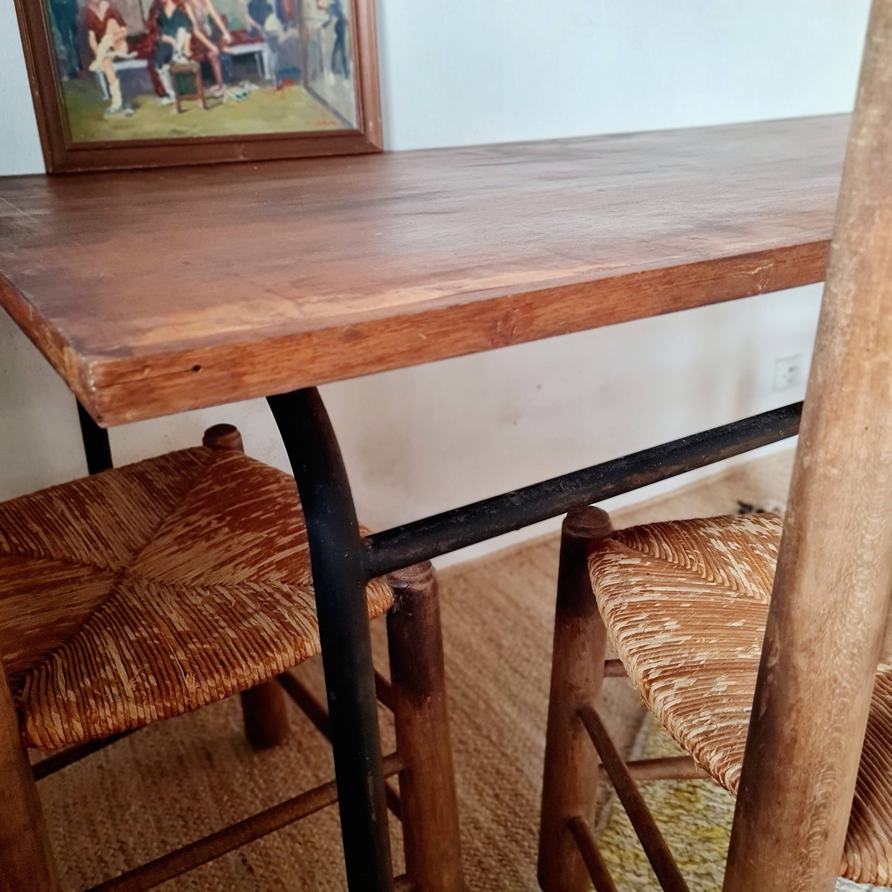 Table with tubular metal legs and wooden top.
