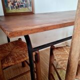 Table with tubular metal legs and wooden top.
