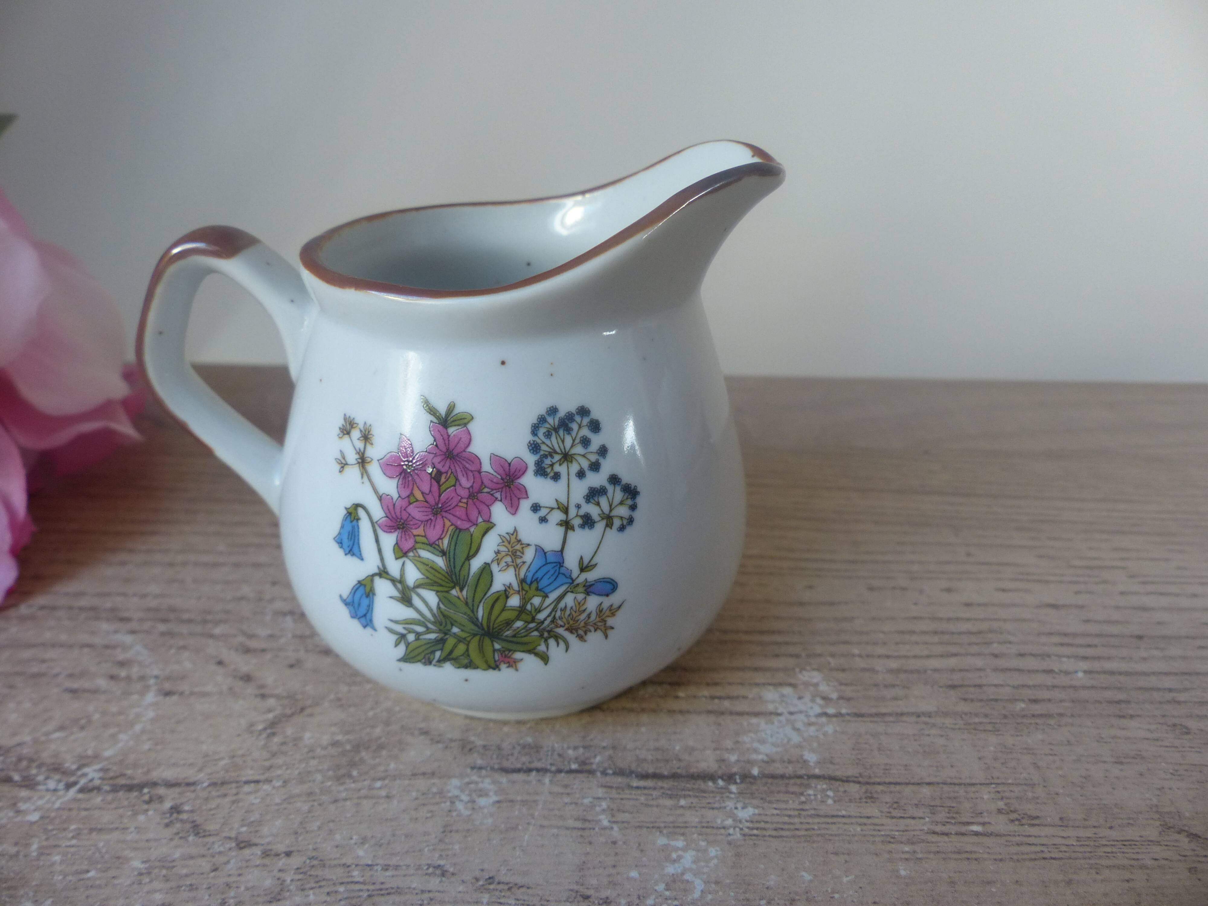 Old small artisanal milk jug in flowered speckled stoneware from the 1980s