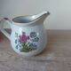 Vintage handmade speckled stoneware milk jug with floral design from the 1980s.