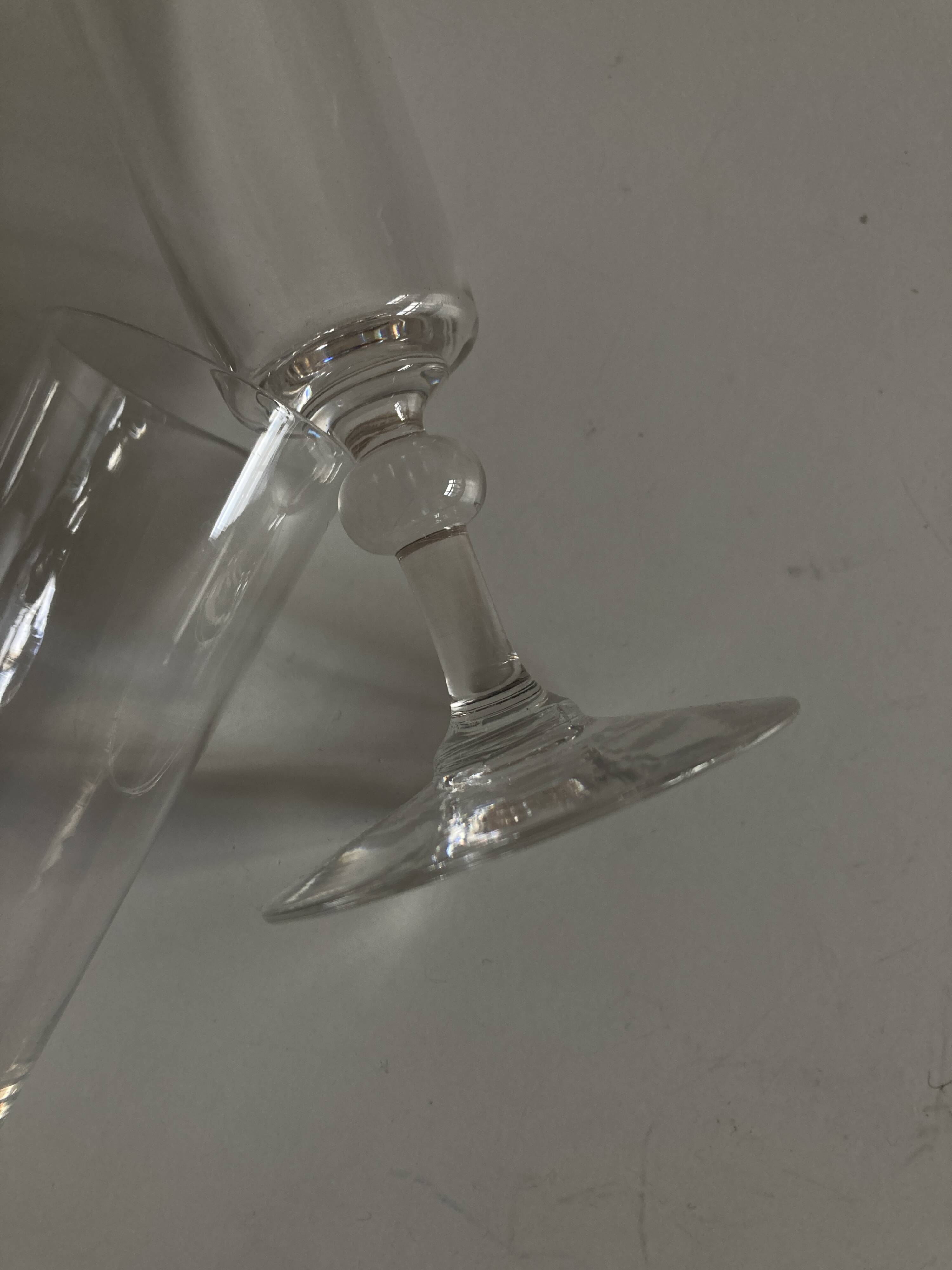 Pair of crystal champagne flutes with a button foot, 1960.