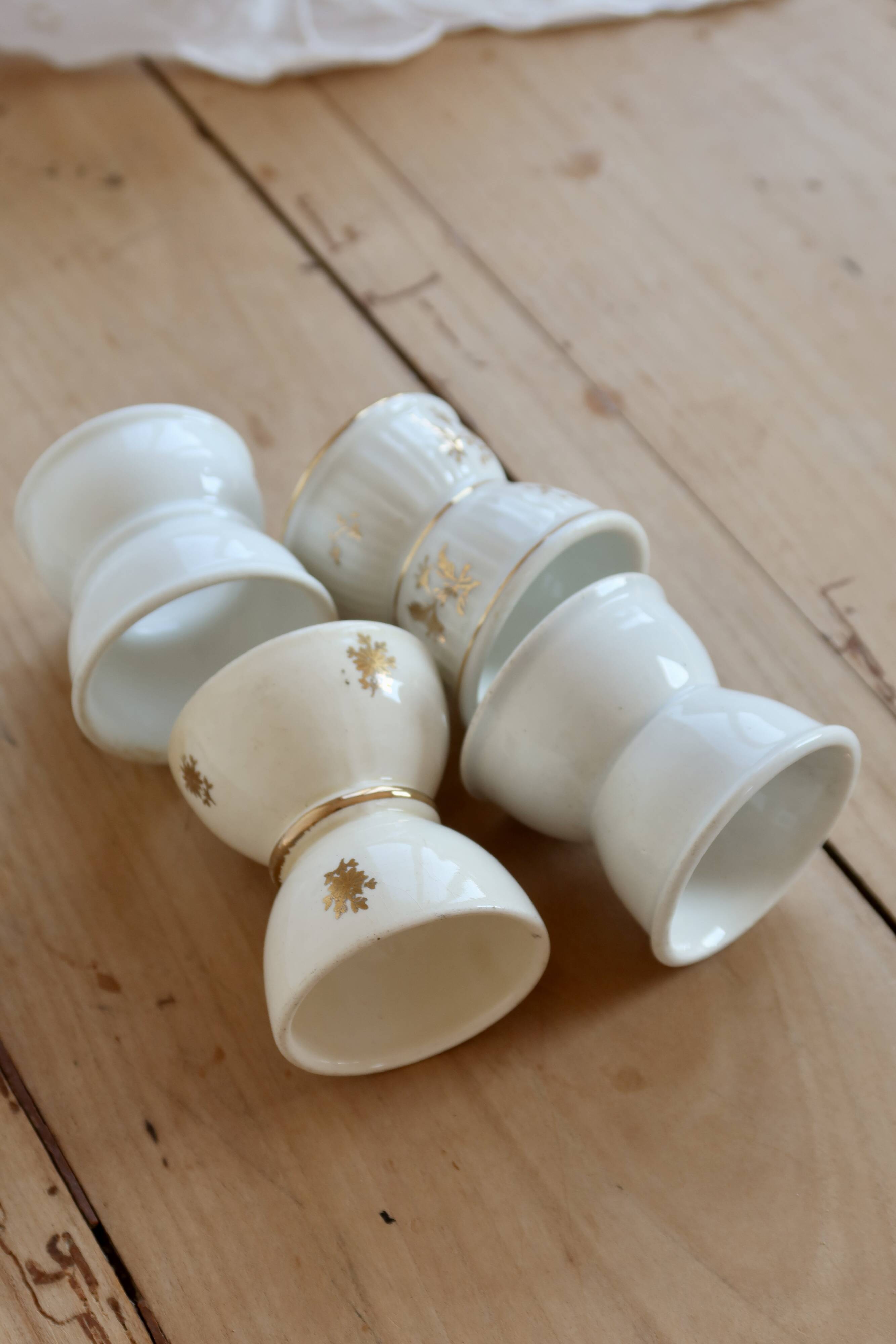 4 mismatched vintage diabolo egg cups in earthenware
