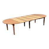 Round extendable banquet table stripped in solid mahogany with 4 extensions, 19th century.