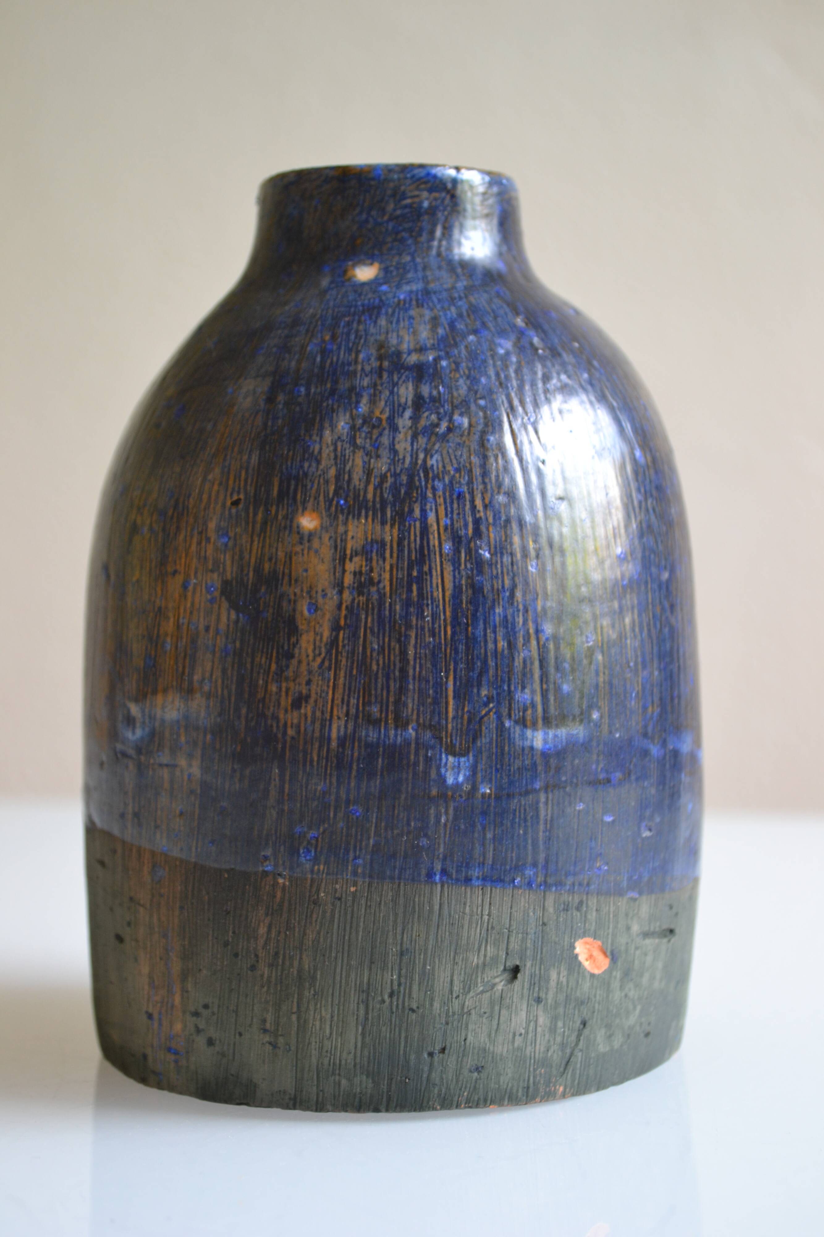Ceramic bottle vase with a fish signature to be identified.