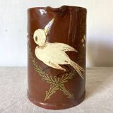 Terracotta pitcher with hand-painted bird decor