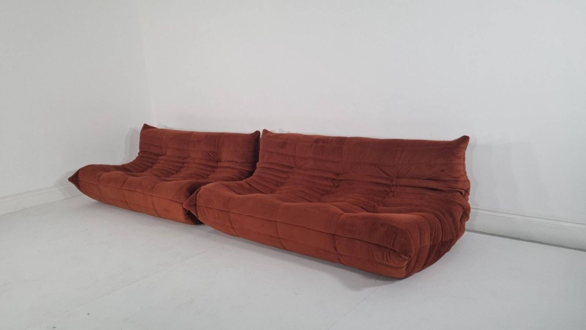 Ligne Roset Pair of 3-seater Togo sofas in rust velvet