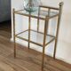 Bedside table in brass and glass.