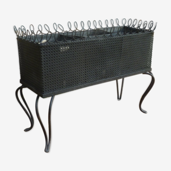 Black perforated metal planter from the 1950s