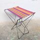 Vintage folding stool with a bayadère fabric pattern.