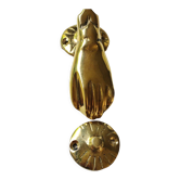 Hand-shaped door knocker. In polished brass, beautiful shine